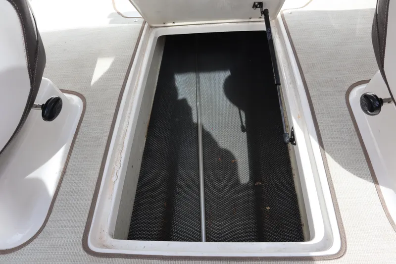 Slide: The Image of Open storage compartment on 2021 Chaparral 21 SSi boat interior. - 20