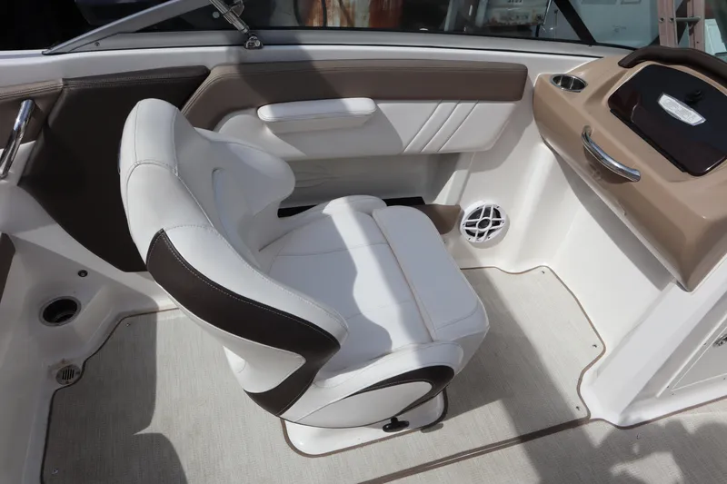 Slide: The Image of 2021 Chaparral 21 SSi boat interior with white and brown seating. - 21
