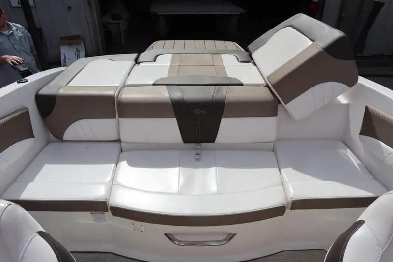 Slide: The Image of 2021 Chaparral 21 SSi boat interior with white and brown cushioned seating. - 27