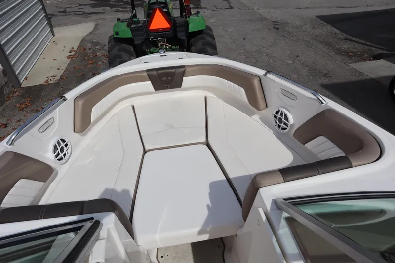 Slide: The Image of 2021 Chaparral 21 SSi boat interior with cushioned seating and speakers. - 4