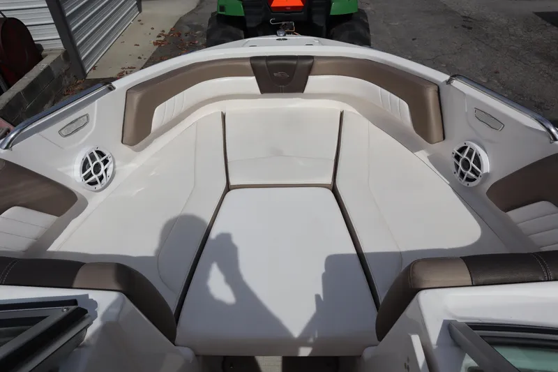 Slide: The Image of 2021 Chaparral 21 SSi boat interior with cushioned seating and built-in speakers. - 5