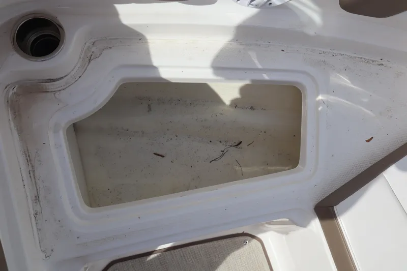 Slide: The Image of Storage compartment on a 2021 Chaparral 21 SSi boat, showing interior details. - 9