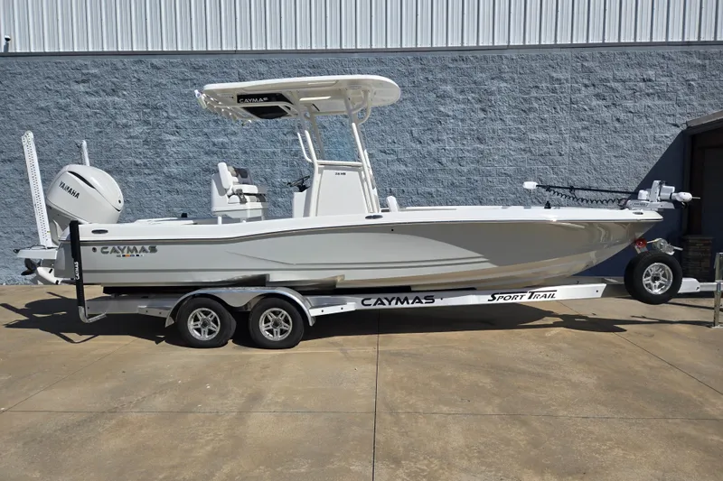 The Image of 2026 Caymas 26 HB boat on trailer, parked outdoors, featuring Yamaha engine. - 1