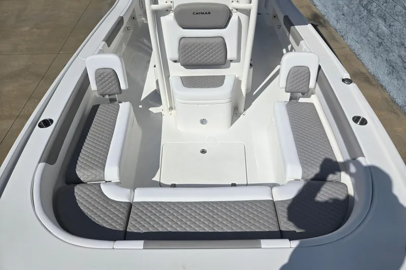 Slide: The Image of 2026 Caymas 26 HB boat interior with gray quilted seating and white accents. - 10