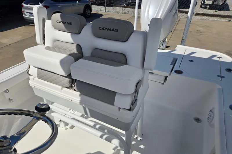 Slide: The Image of 2026 Caymas 26 HB boat interior with dual cushioned seats and steering wheel. - 12