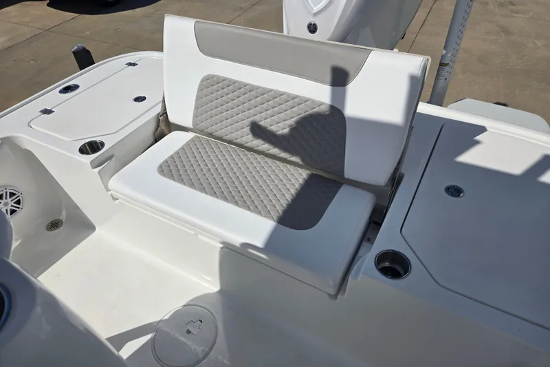 Slide: The Image of 2026 Caymas 26 HB boat seating area with quilted upholstery and storage compartments. - 14