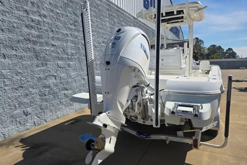 Slide: The Image of 2026 Caymas 26 HB boat with Yamaha V6 engine, parked outdoors. - 3