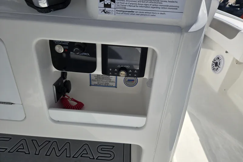 Slide: The Image of Control panel of 2026 Caymas 26 HB boat with audio system and safety instructions. - 7