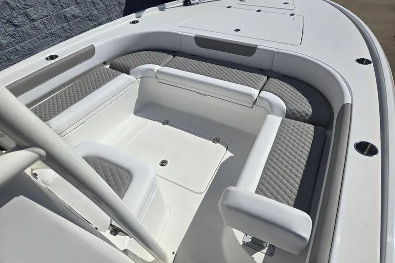 Slide: The Image of 2026 Caymas 26 HB boat interior with cushioned seating and storage compartments. - 8