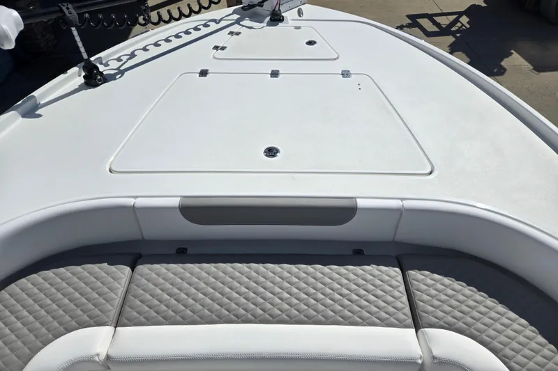 Slide: The Image of 2026 Caymas 26 HB boat deck with quilted seating and storage compartments. - 9