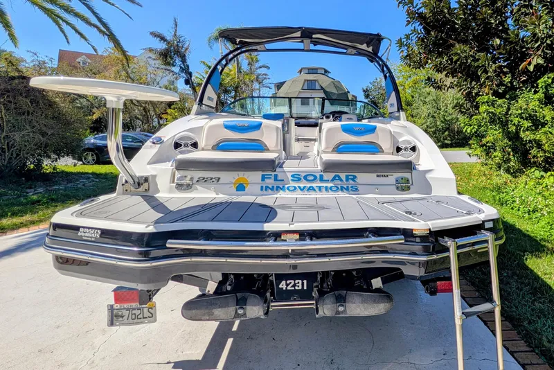 Slide: The Image of 2017 Chaparral Vortex 223 VRX boat with FL Solar Innovations branding, parked outdoors. - 15