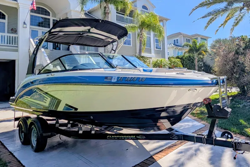 Slide: The Image of 2017 Chaparral Vortex 223 VRX boat on trailer, parked in front of a house. - 19