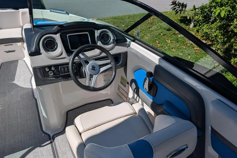 Slide: The Image of 2017 Chaparral Vortex 223 VRX boat cockpit with steering wheel and dashboard controls. - 8