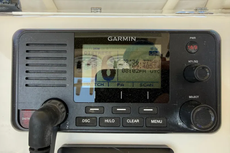Slide: The Image of Garmin marine radio on 2017 Cobia 296 Center Console, displaying distress signal. - 12