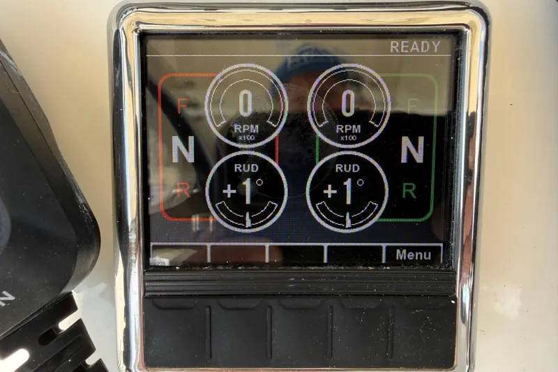 Slide: The Image of Digital display panel on a 2017 Cobia 296 Center Console boat showing RPM and rudder angle. - 14