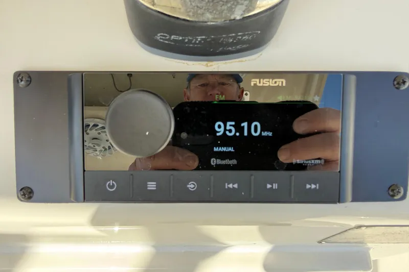 Slide: The Image of Fusion marine stereo display on 2017 Cobia 296 Center Console, tuned to 95.10 MHz. - 15