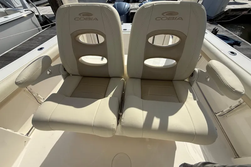 Slide: The Image of 2017 Cobia 296 Center Console boat seats with armrests and logo. - 17