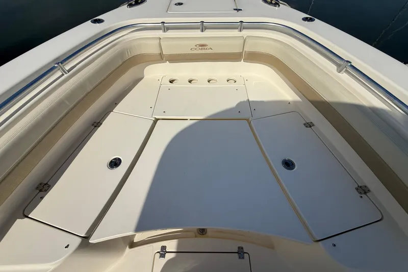 Slide: The Image of 2017 Cobia 296 Center Console boat interior with storage compartments and seating. - 22