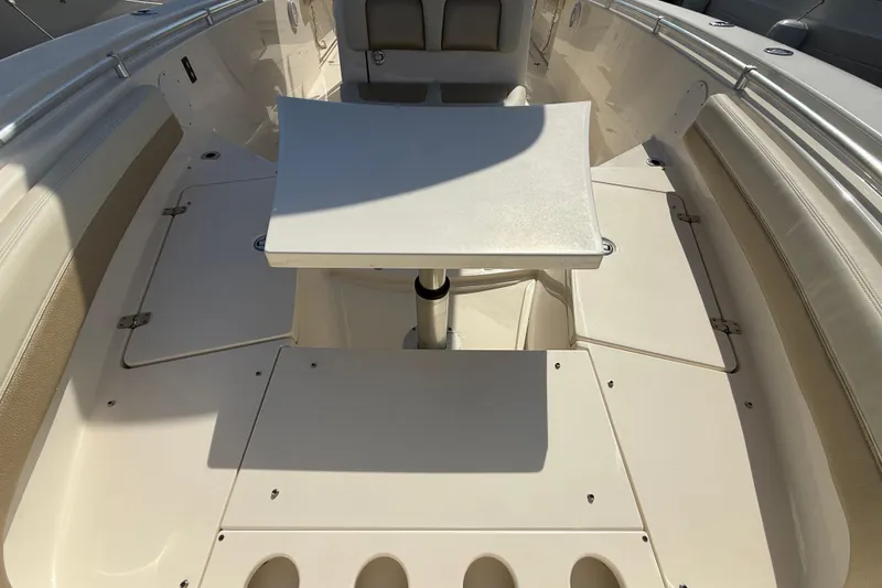Slide: The Image of 2017 Cobia 296 Center Console boat interior with seating and table. - 24
