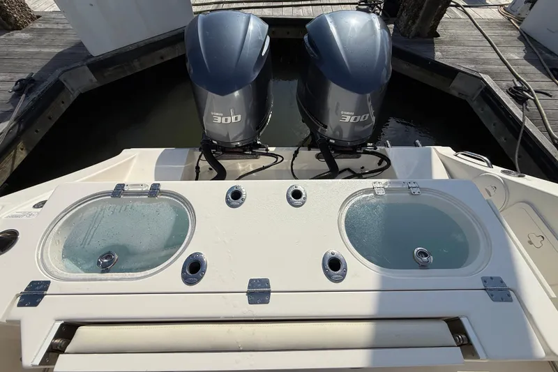 Slide: The Image of 2017 Cobia 296 Center Console with twin Yamaha 300 engines at dock. - 29