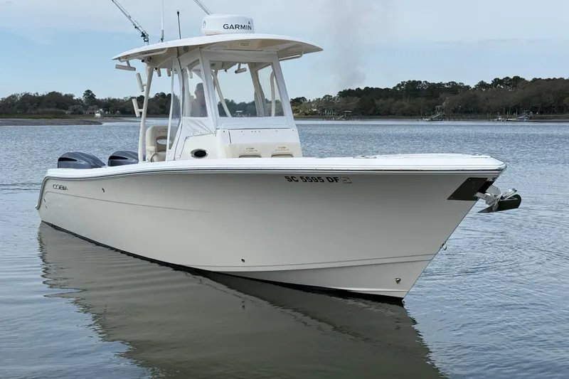 Slide: The Image of 2017 Cobia 296 Center Console boat on calm water, featuring Garmin equipment. - 3