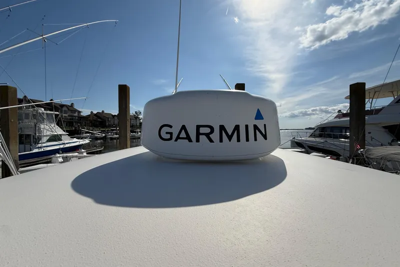 Slide: The Image of Garmin radar on 2017 Cobia 296 Center Console boat, docked under a sunny sky. - 32