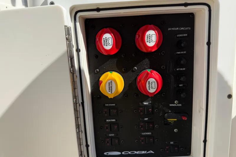 Slide: The Image of Control panel of a 2017 Cobia 296 Center Console boat with labeled switches. - 36