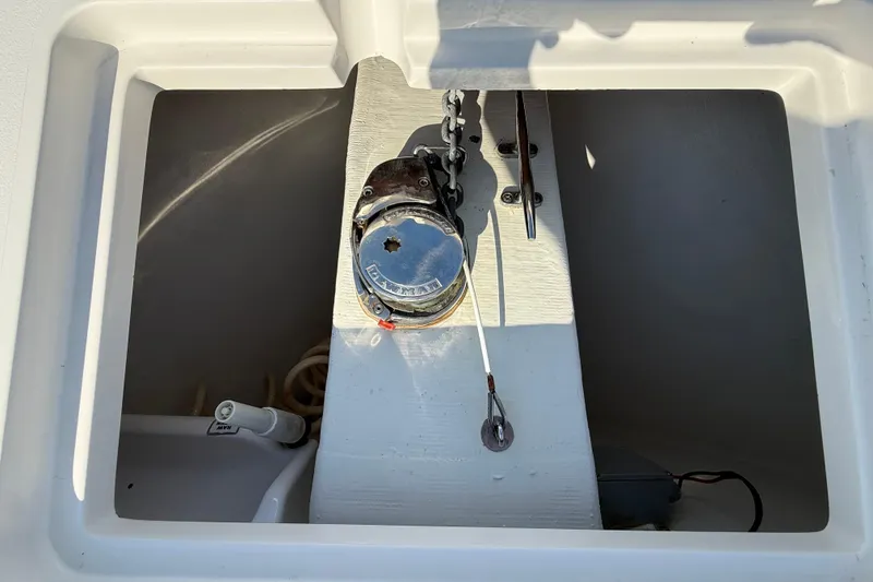 Slide: The Image of 2017 Cobia 296 Center Console anchor compartment with winch and chain. - 37