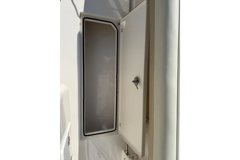 Slide: The Image of Open storage compartment on a 2017 Cobia 296 Center Console boat. - 38