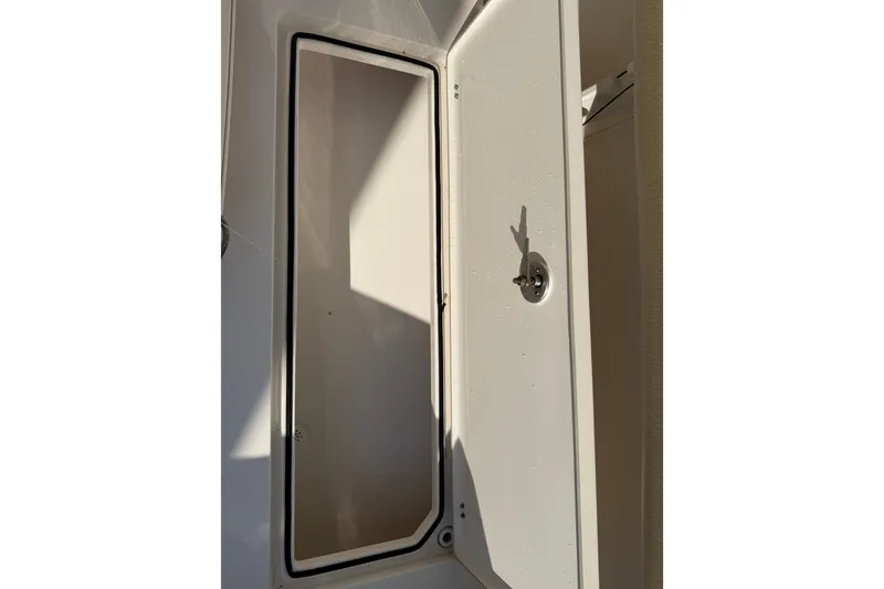 Slide: The Image of Open storage compartment on a 2017 Cobia 296 Center Console boat. - 39