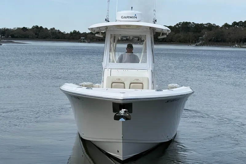 Slide: The Image of 2017 Cobia 296 Center Console boat on calm water, featuring Garmin equipment. - 4