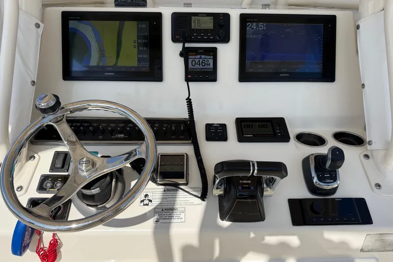 Slide: The Image of 2017 Cobia 296 Center Console dashboard with Garmin displays and Yamaha controls. - 7