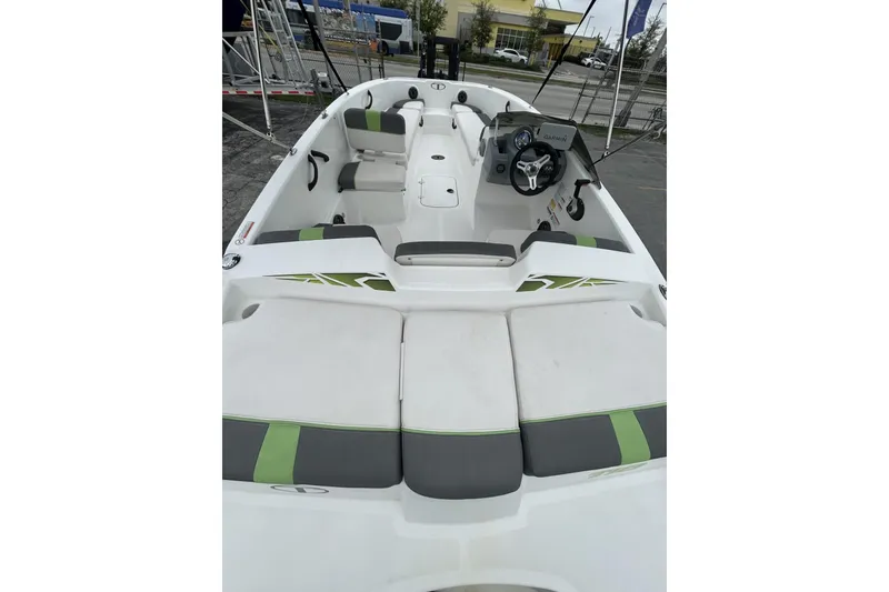 Slide: The Image of 2022 Tahoe T18 boat interior with seating and steering wheel, featuring green and gray accents. - 34