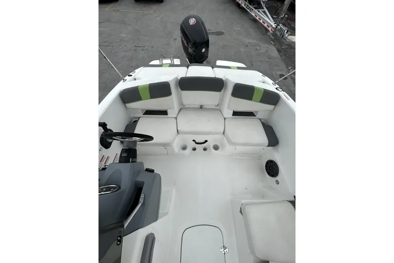 Slide: The Image of 2022 Tahoe T18 boat interior with cushioned seating and steering console. - 38