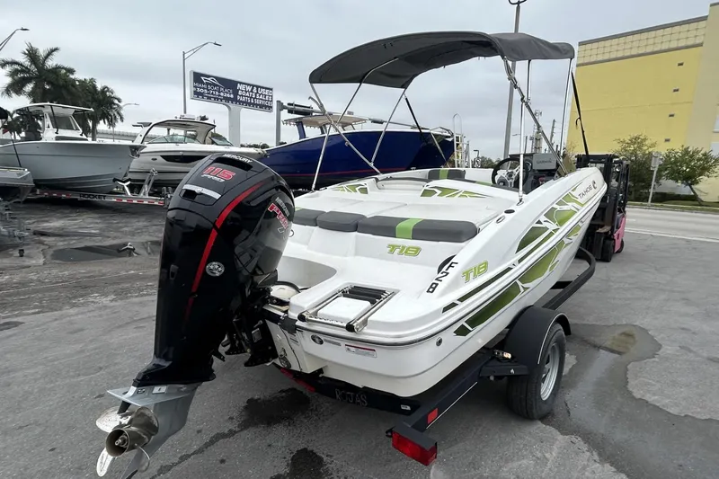 Slide: The Image of 2022 Tahoe T18 boat with Mercury 115 engine on trailer, parked outdoors. - 39