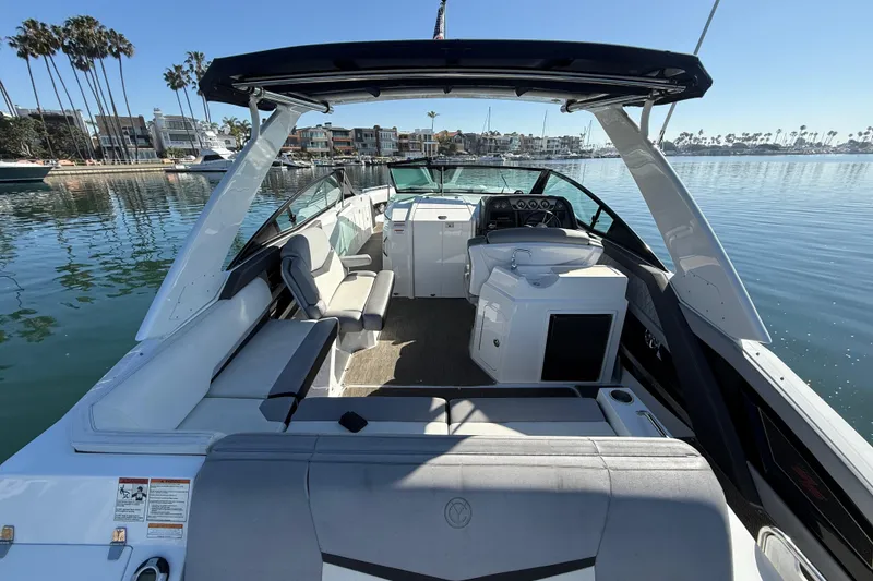 Slide: The Image of 2015 Cruisers Yachts 338 Bow Rider on calm water, showcasing spacious seating and helm. - 12