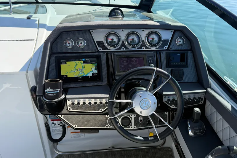Slide: The Image of Dashboard of a 2015 Cruisers Yachts 338 Bow Rider with navigation system and controls. - 13