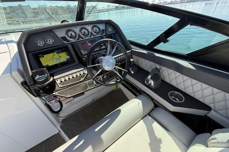 Slide: The Image of 2015 Cruisers Yachts 338 Bow Rider dashboard with steering wheel and navigation system. - 14