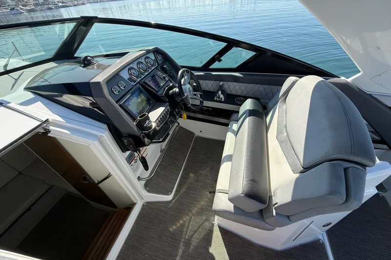 Slide: The Image of 2015 Cruisers Yachts 338 Bow Rider helm with modern controls and comfortable seating. - 15