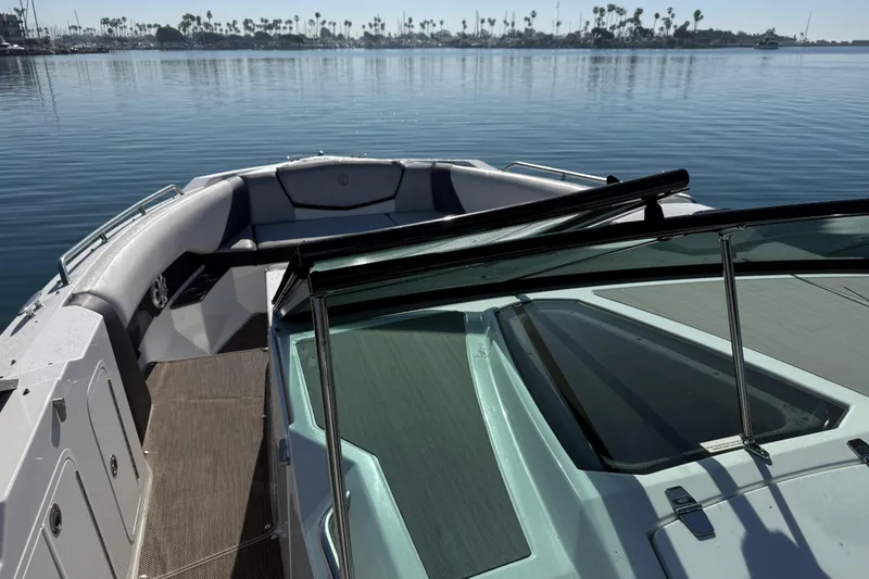 Slide: The Image of 2015 Cruisers Yachts 338 Bow Rider on calm water, showcasing spacious seating and sleek design. - 16