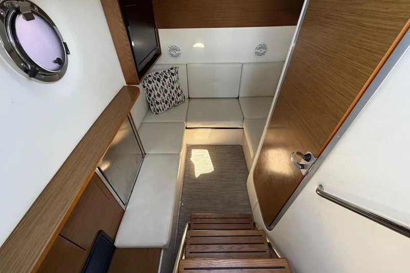 Slide: The Image of Interior of 2015 Cruisers Yachts 338 Bow Rider with seating and wooden accents. - 18