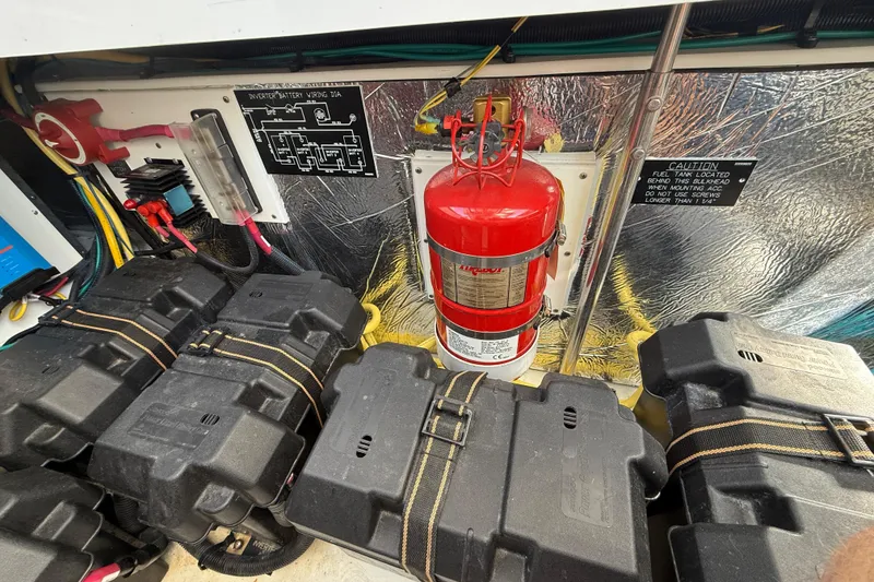 Slide: The Image of Engine compartment of 2015 Cruisers Yachts 338 Bow Rider with fire extinguisher and battery setup. - 26