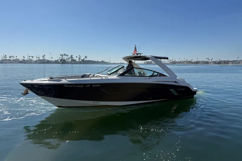 Slide: The Image of 2015 Cruisers Yachts 338 Bow Rider on calm water, clear sky background. - 5