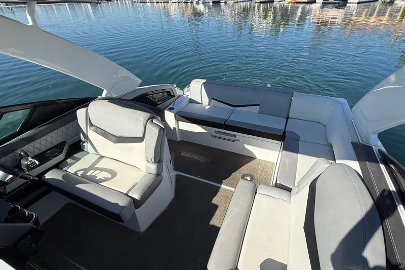 Slide: The Image of 2015 Cruisers Yachts 338 Bow Rider interior with plush seating on calm water. - 7
