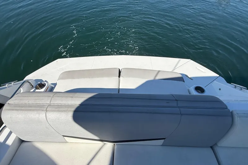 Slide: The Image of 2015 Cruisers Yachts 338 Bow Rider with rear seating, overlooking calm water. - 9