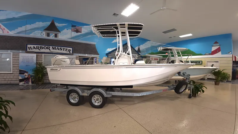 Slide: The Image of Boston Whaler 190 Montauk 2026 in a showroom on a trailer. - 0
