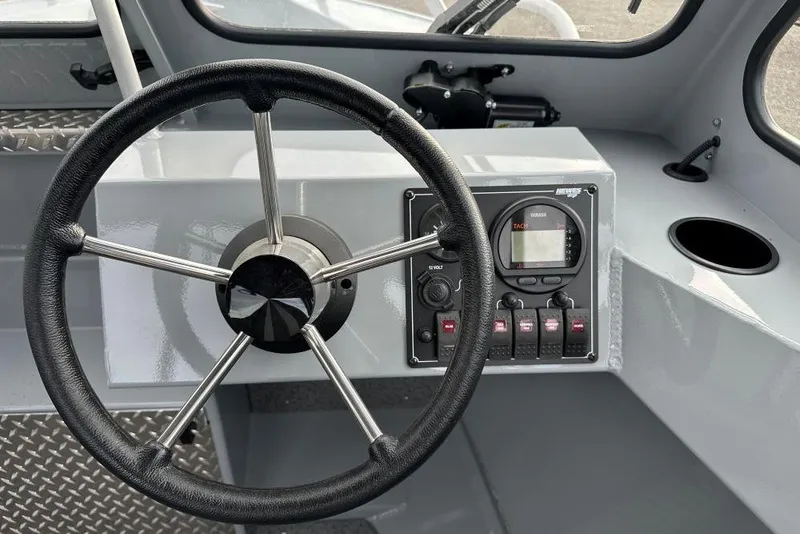 Slide: The Image of Steering wheel and dashboard of 2026 Hewescraft 160 Sportsman boat. - 4