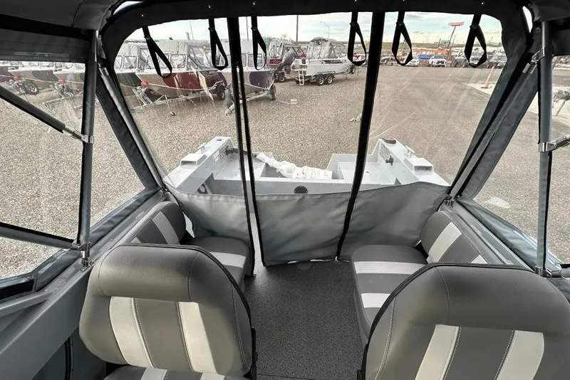 Slide: The Image of 2026 Hewescraft 160 Sportsman boat interior with gray seating and protective canopy. - 5
