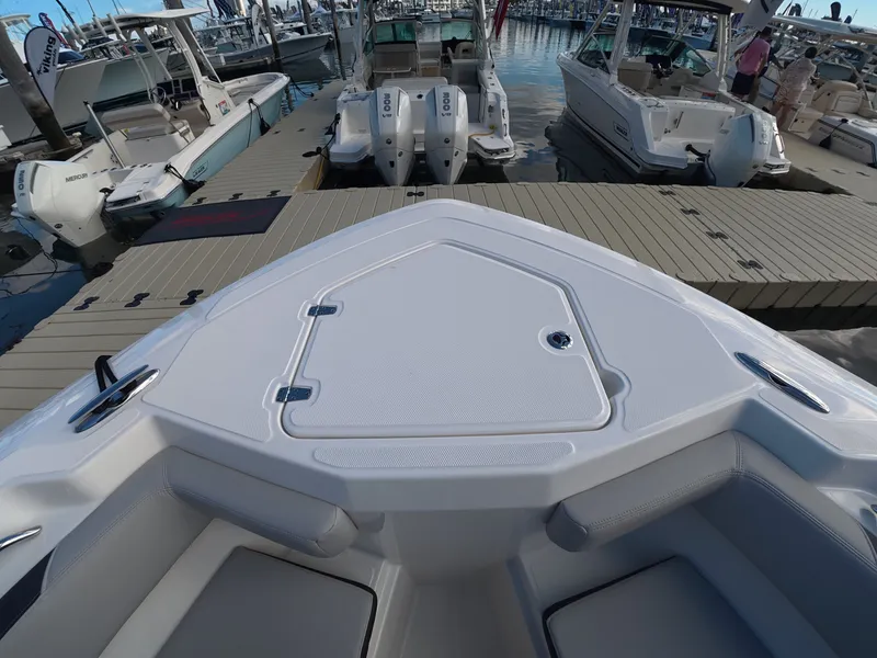 Slide: The Image of The image shows the bow of a Boston Whaler 330 Outrage docked at a marina. - 25