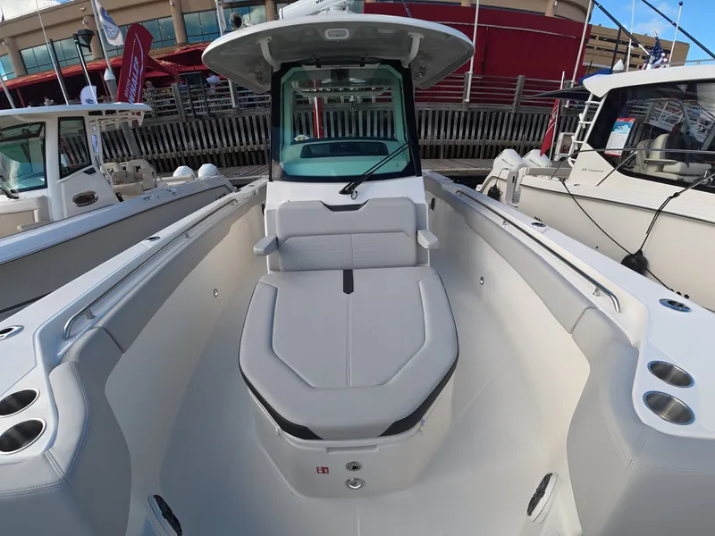 Slide: The Image of The image shows the cockpit of a 2027 Boston Whaler 330 Outrage with sleek seating. - 20